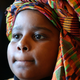 Symba Nureddin, 9, watches the festivities during a Kwanzaa festival at the Museum of Natural History Dec.28, 2002, in New York City.